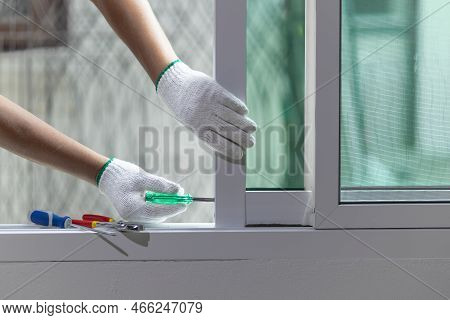 Construction Worker Is Repairing The Sliding Window.
