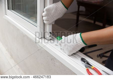 Construction Worker Is Repairing The Sliding Window.