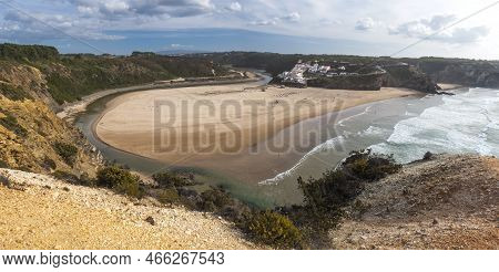 Panoramic View Of Praia De Odeceixe Mar Surfer Beach With Golden Sand, Atlantic Ocean Waves, River B