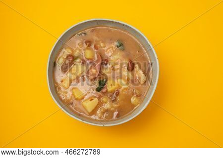 Sopa De Pedra Portuguese Stone Soup With Beans And Sausages In The Plate On Yellow Paper.