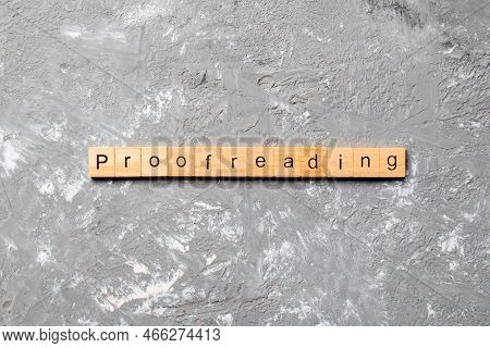 Proofreading Word Written On Wood Block. Proofreading Text On Table, Concept.