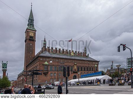 Copenhagen, Denmark - July 23, 2022: Large Red Brick Town Hall With Clock And Bell Tower Dominates B