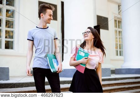 Smiling Students Going Downstairs After Clasees, Having Conversation, Holding Learning Materials Hap