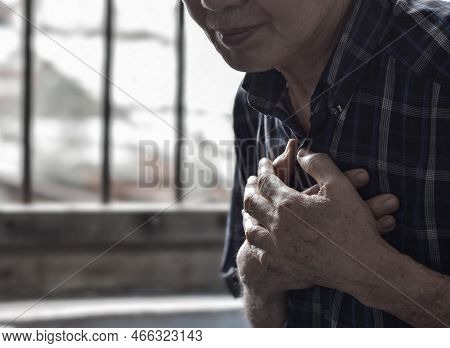 Asian Elder Man Suffering From Central Chest Pain. Chest Pain Can Be Caused By Heart Attack, Myocard