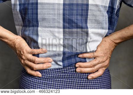 Asian Elder Man Suffering From Back And Loin Pain. It Can Be Caused By Renal Stone.