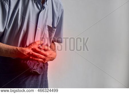 Asian Elder Man Suffering From Upper Abdominal Pain. It Can Be Caused By Stomach Ache, Enteritis, Co