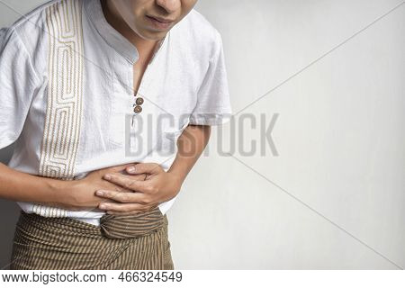 Asian Young Man Suffering From Upper Abdominal Pain. It Can Be Caused By Stomach Ache, Enteritis, Co