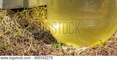 Plastic Bottle With Dirty Water Inside. Yellow Glow