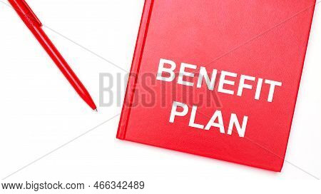 The Text Benefit Plan Is Written On A Red Notepad Near A Red Pen On A White Table In The Office. Bus