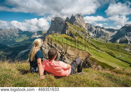 A Couple Enjoy Landscape Of Seceda Peak In Dolomites Alps, Odle Mountain Range, South Tyrol, Italy, 