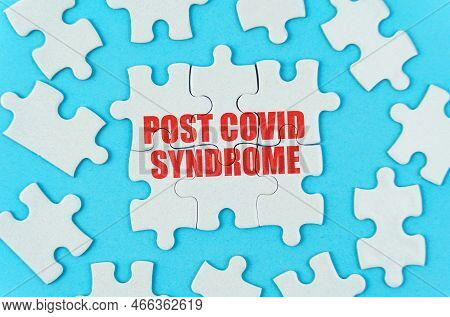 Medical Concept. On A Blue Background Are White Puzzles With The Inscription - Post Covid Syndrome