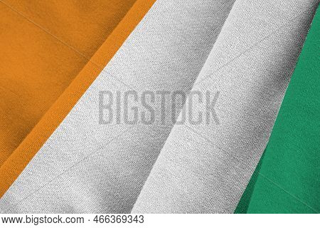 Ivory Coast Flag With Big Folds Waving Close Up Under The Studio Light Indoors. The Official Symbols