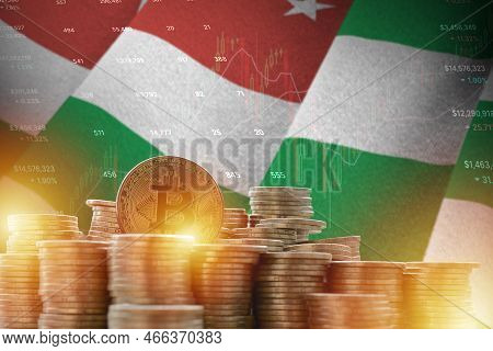 Abkhazia Flag And Big Amount Of Golden Bitcoin Coins And Trading Platform Chart. Crypto Currency Con