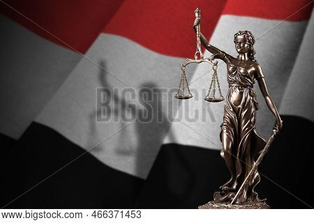 Yemen Flag With Statue Of Lady Justice And Judicial Scales In Dark Room. Concept Of Judgement And Pu