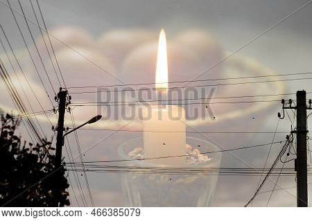 Blackout - Power Grid Overloaded. Blackout Concept. Earth Hour. Burning Flame Candle And Power Lines
