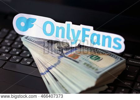 Ternopil, Ukraine - September 6, 2022 Onlyfans Paper Logotype On Bunch Of Us Dollar Bills Lies On Bl