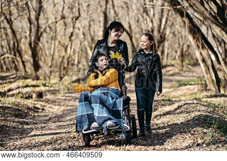 Diversity And Inclusion. Happy Family, Mother, Daughter And Son Teen Boy With Cerebral Palsy Spendin
