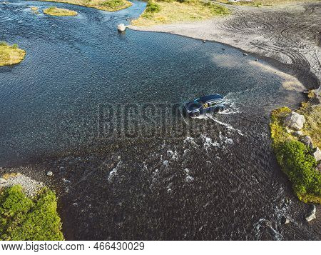 Car Driving Across Water Somewhere In Iceland