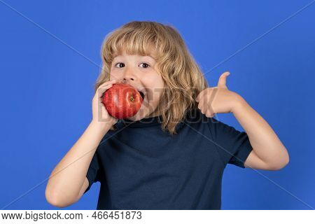 Red Apple. Little Boy Biting Apple With Fynny Face. Kid Eats Healthy Food.