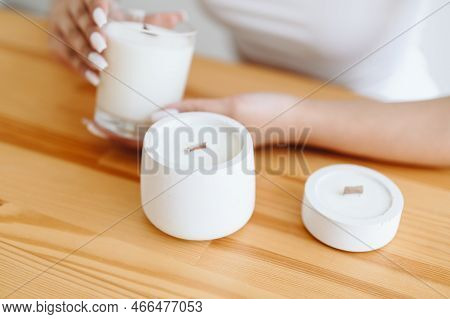 Place Under Label On Soy White Candles. Group Of White Candles Stand On Wooden Table. Women's H\hand