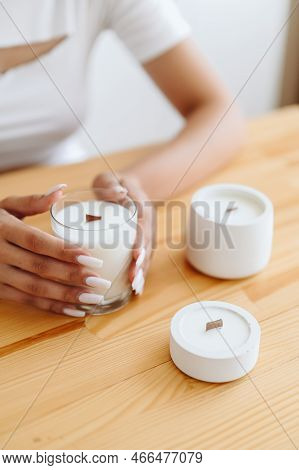 Place Under Label On Soy White Candles. Group Of White Candles Stand On Wooden Table. Women's H\hand