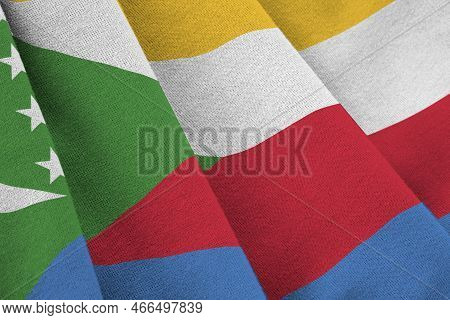 Comoros Flag With Big Folds Waving Close Up Under The Studio Light Indoors. The Official Symbols And