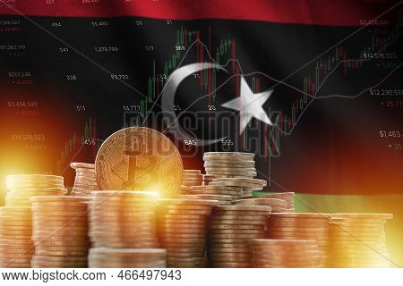 Libya Flag And Big Amount Of Golden Bitcoin Coins And Trading Platform Chart. Crypto Currency Concep