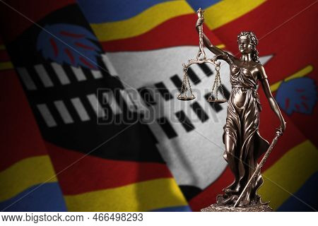 Swaziland Flag With Statue Of Lady Justice And Judicial Scales In Dark Room. Concept Of Judgement An