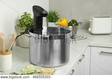 Pot With Sous Vide Cooker In Kitchen. Thermal Immersion Circulator
