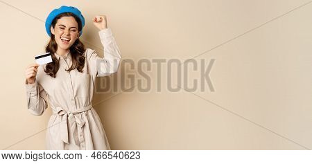 Enthusiastic Young Woman Yearning To Go Shopping, Dancing With Credit Card And Celebrating, Laughing