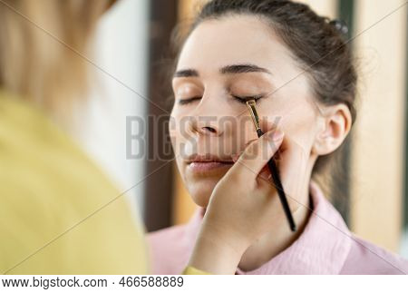 Beauty Stylist Applying Make-up To A Young Model.professional Make-up Artist Doing Glamour