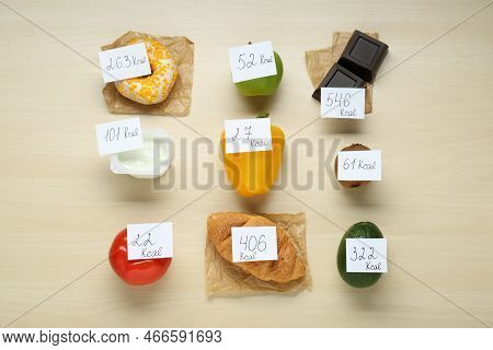 Food Products With Calorific Value Tags On Wooden Table, Flat Lay. Weight Loss Concept