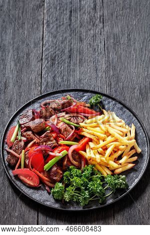Lomo Saltado, Peruvian Dish Of Stir-fried Slices Of Beef Sirloin, Onions, Yellow Peruvian Chilis, An