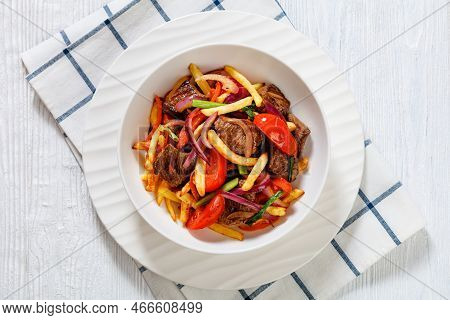 Lomo Saltado, Peruvian Dish Of Stir-fried Slices Of Beef Sirloin, Onions, Yellow Peruvian Chilis, An