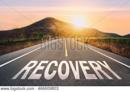 Recovery Written On Highway Road In The Middle Of Empty Asphalt Road Of Asphalt Road At Sunset.road 
