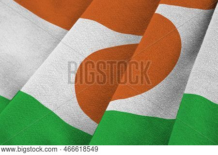 Niger Flag With Big Folds Waving Close Up Under The Studio Light Indoors. The Official Symbols And C