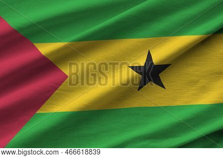 Sao Tome And Principe Flag With Big Folds Waving Close Up Under The Studio Light Indoors. The Offici