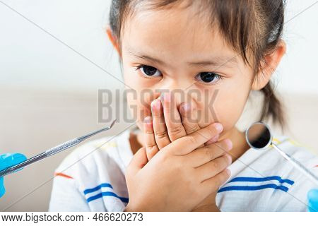 Dental Kid Examination. Doctor Examines Oral Cavity Of Child Uses Mouth Mirror To Check Teeth Cavity