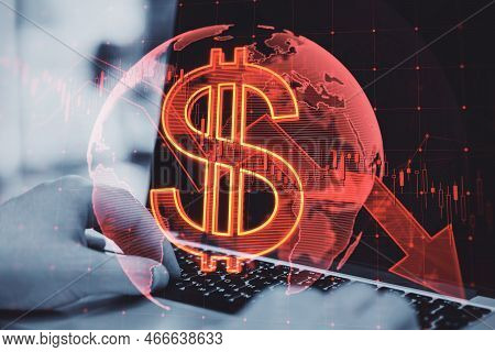 Close Up Of Hands Using Laptop Computer With Falling Global Red Dollar Arrow Hologram On Blurry Back