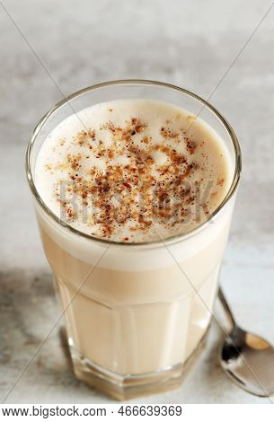 Coffee With Milk And Grated Nut In A Glass Close-up. Raff Coffee.