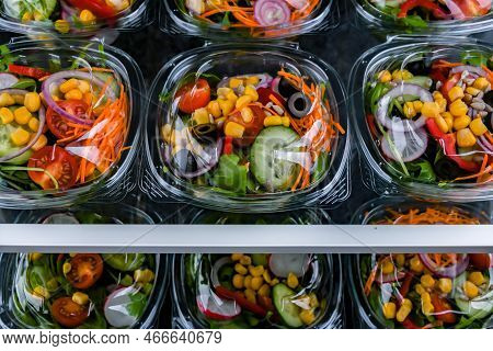 Boxes With Pre-packaged Vegetable Salads In A Commercial Fridge