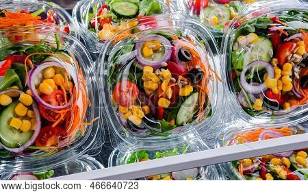 Plastic Boxes With Pre-packaged Vegetable Salads, Put Up For Sale In A Commercial Refrigerator