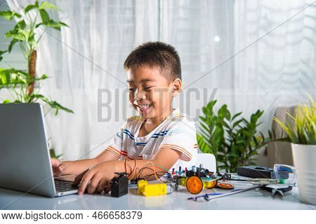 Asian Kid Boy Learns Coding And Programming With Laptop For Arduino Robot Car, Little Child Students