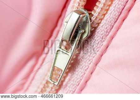 Pink Plastic Zip Fastener With Metal Detail Close Up.