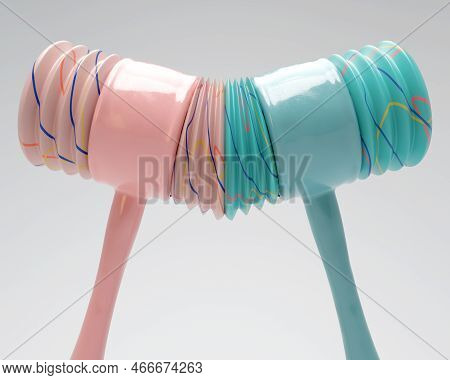Two Opposing Plastic Childrens Squeaking Hammers Striking Each Other On An Isolated Background - 3d 