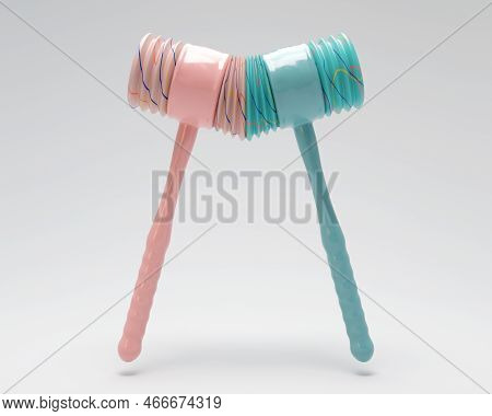 Two Opposing Plastic Childrens Squeaking Hammers Striking Each Other On An Isolated Background - 3d 