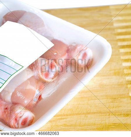 Fresh Uncooked Chicken Meat Drumsticks Pieces, In Package Baget Ready To Cook, On Cutting Board