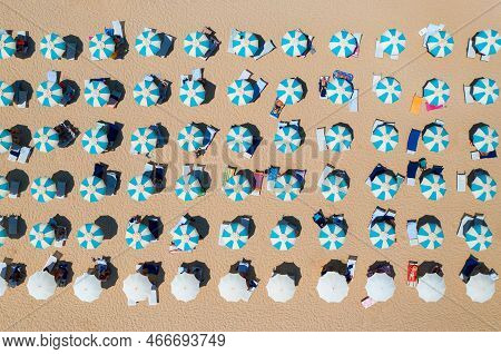 Aerial View Of Colorful Umbrellas On Sandy Beach