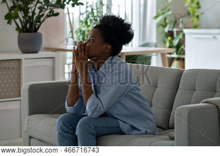 Discouraged Pensive African American Woman Looking Into Distance Thinking About Ways To Solve Financ
