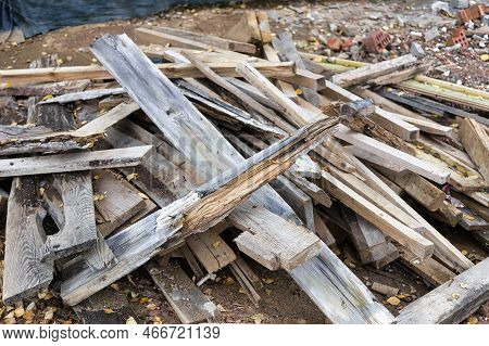 Remains Of Planks With Nails After The Installation Of Concrete Formwork. Recycling Of Lumber. Backg